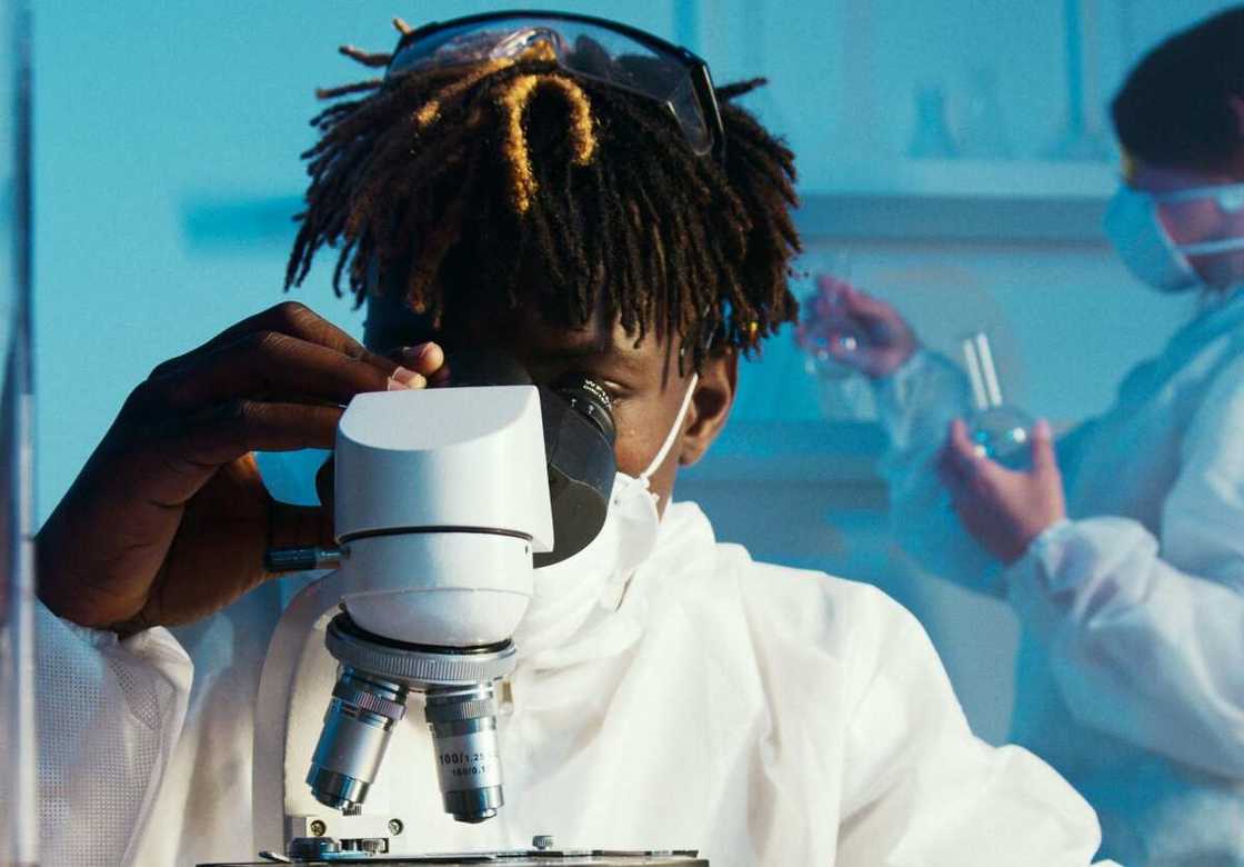 A man looking through the microscope A man looking through the microscope