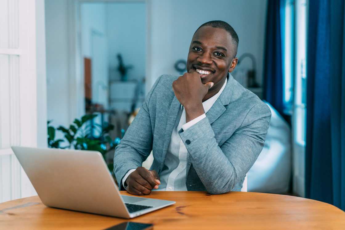A young businessman working on a laptop in the office.