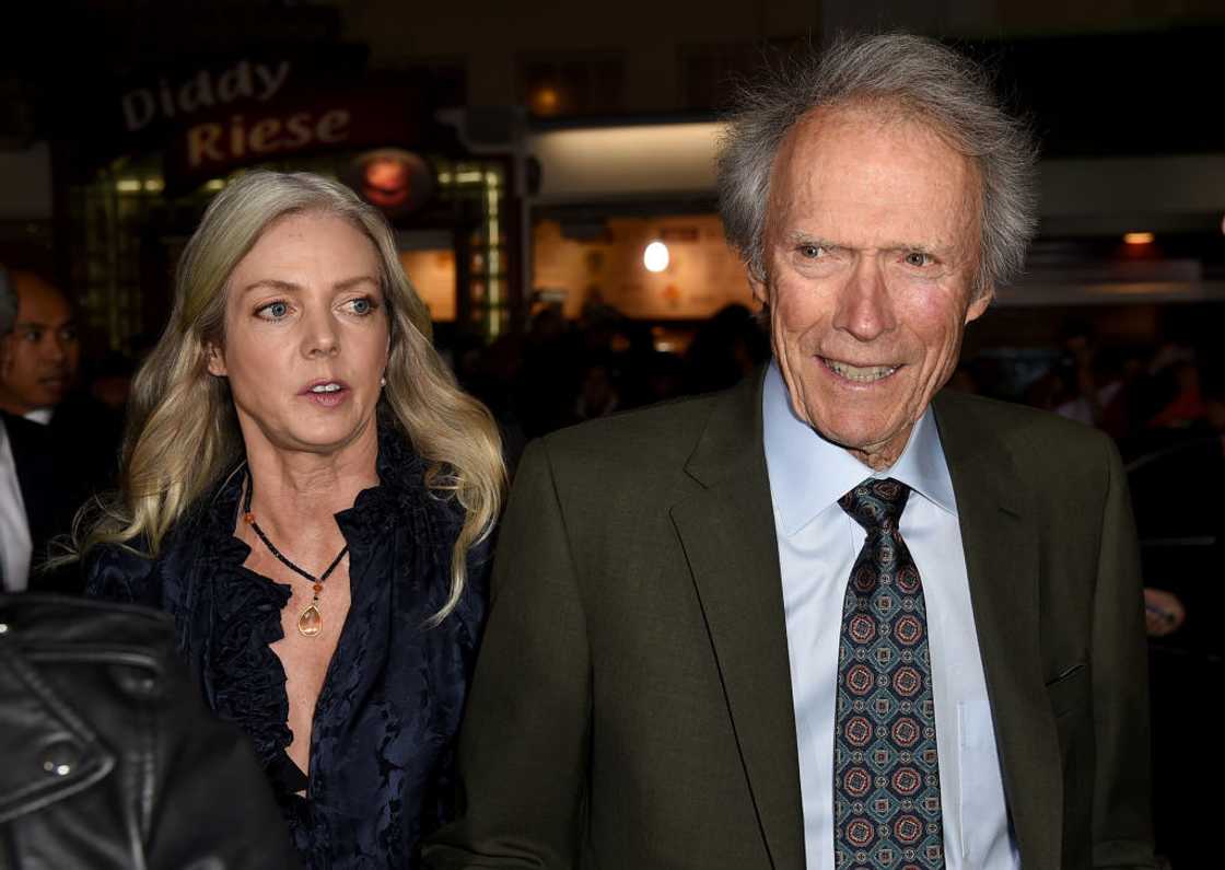 Christina Sandera (L) and Clint Eastwood (R) walking into the Village Theatre