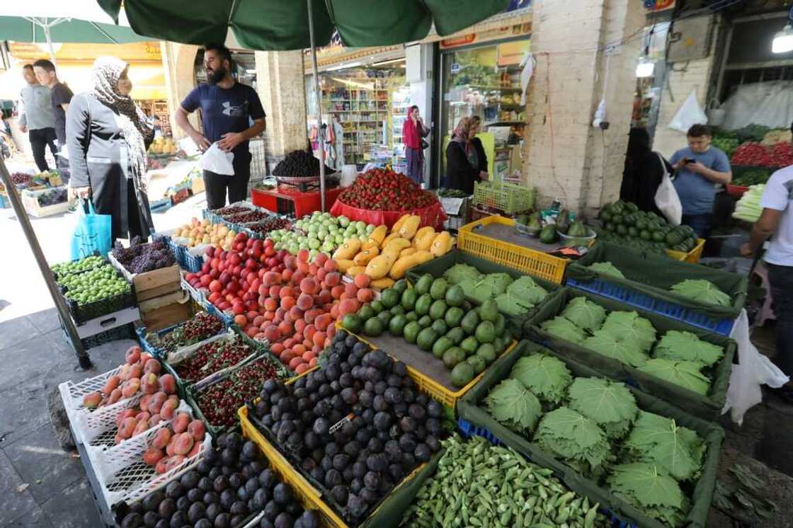 Iranians buy fresh produce at the Tajrish Bazaar market in Tehran. Inflation is making an unwelcome comeback globally -- stoked by high energy and food prices, driven largely by Russia's invasion of Ukraine, and by related sanctions on Moscow