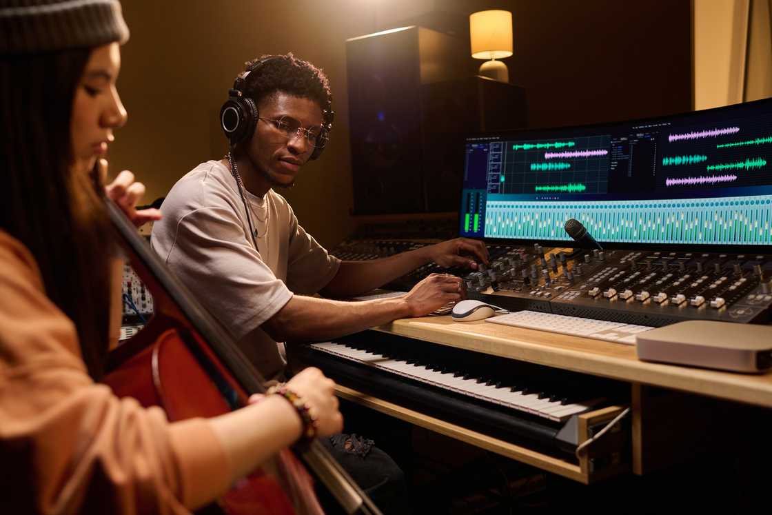 A man and a woman working at a recording studio A man and a woman working at a recording studio