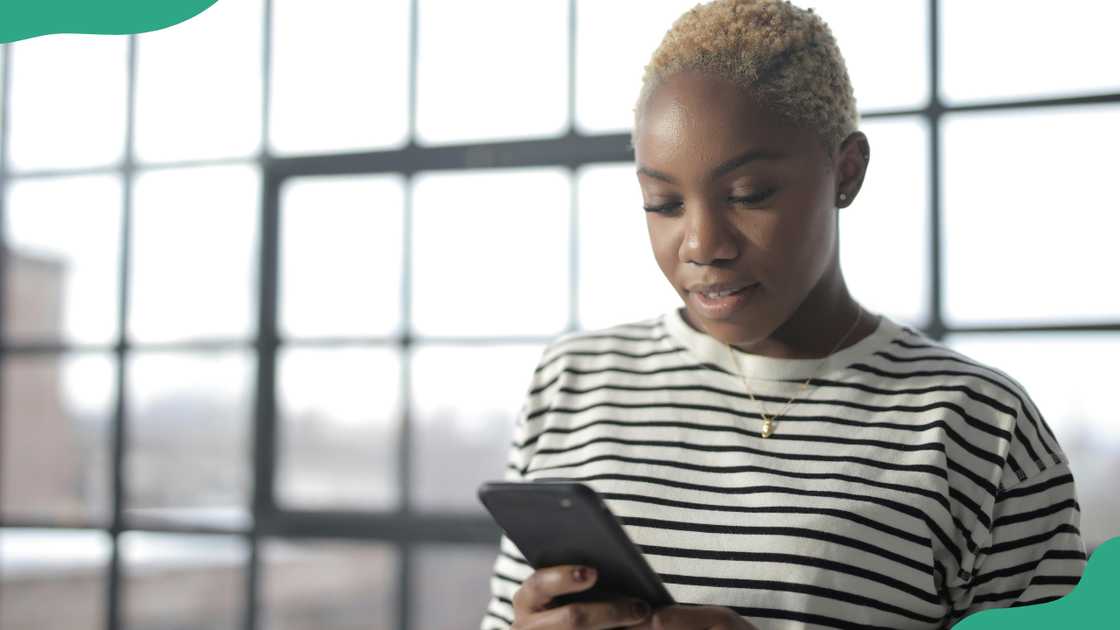 A young lady checks her phone