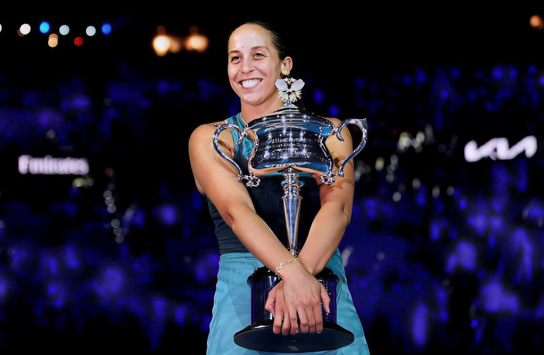 Madison Keys smiles while holding her trophy
