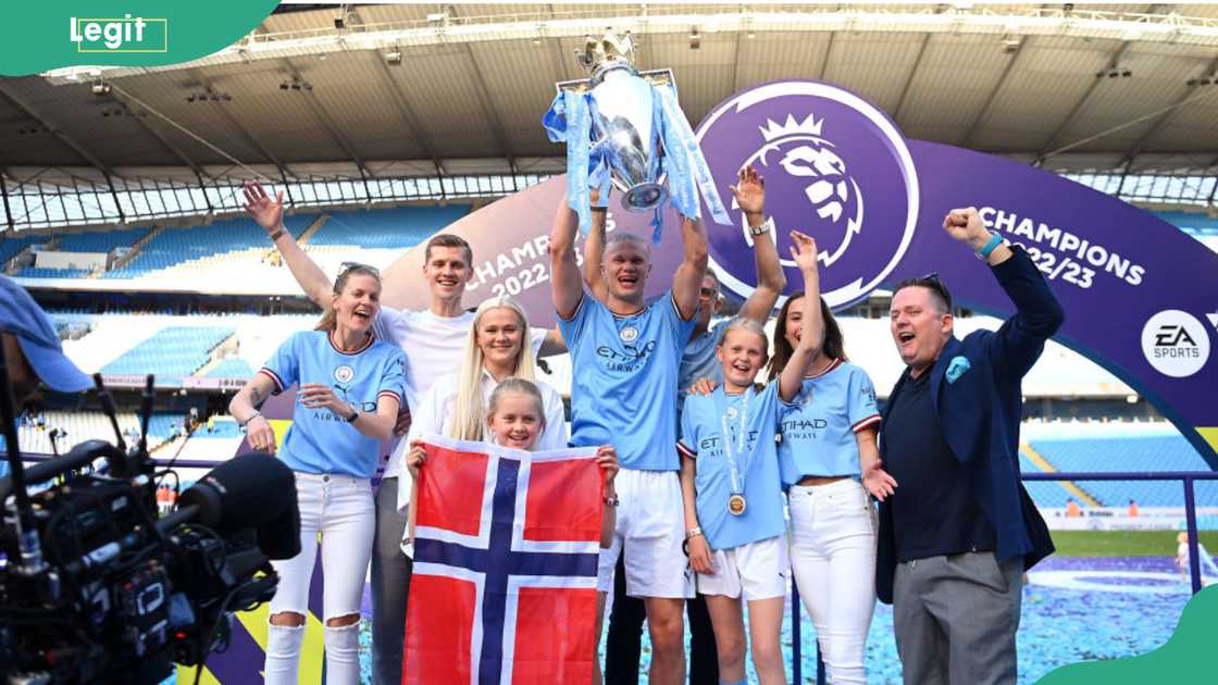 Erling Haaland and family members lifting the English Premiere League trophy