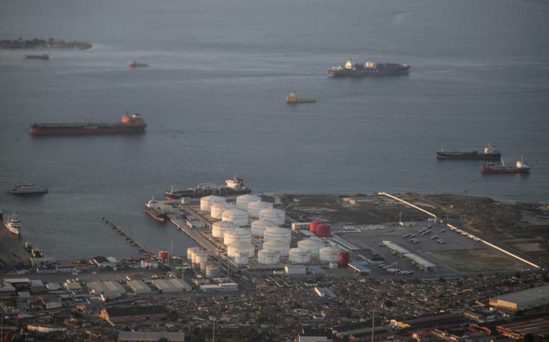 Cargo ships outside an oil and gas storage facility at a port in Luanda, the capital of Angola Cargo ships outside an oil and gas storage facility at a port in Luanda, the capital of Angola