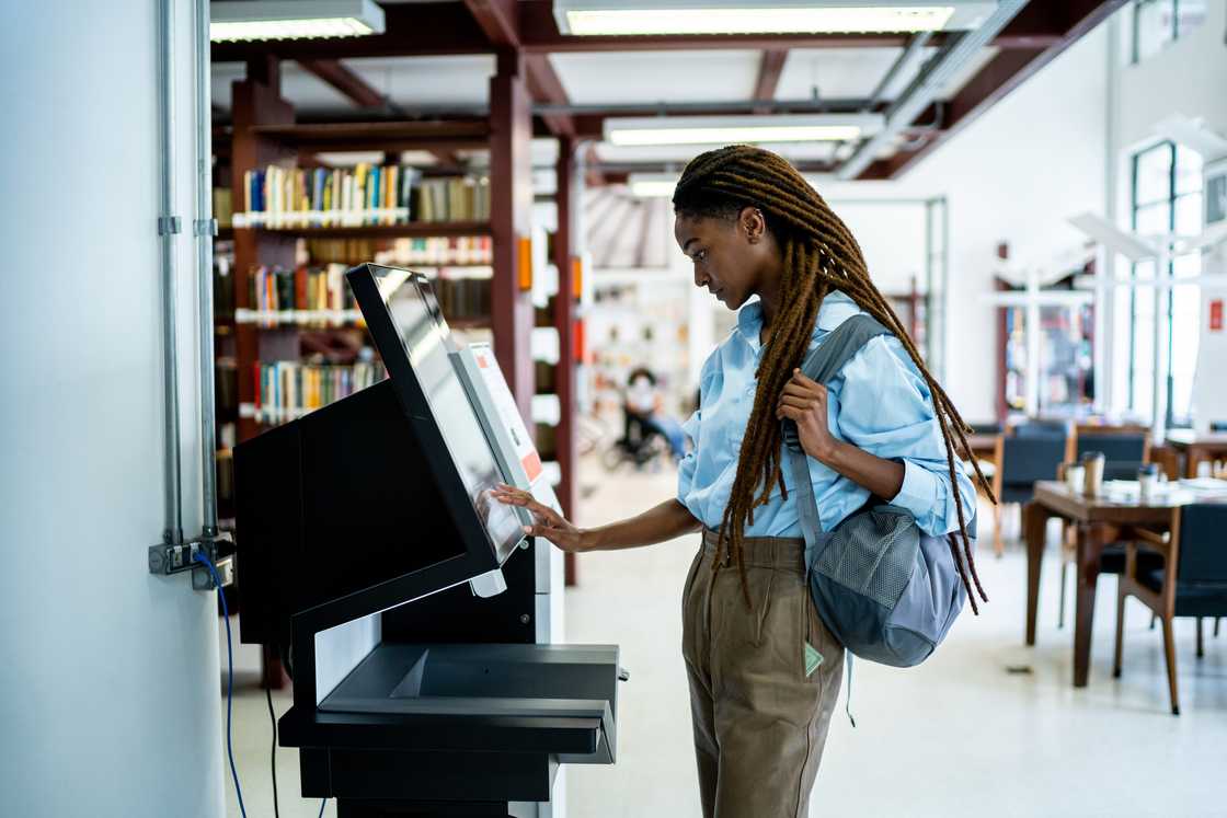 A student using a digital catalogue at a library A student using a digital catalogue at a library