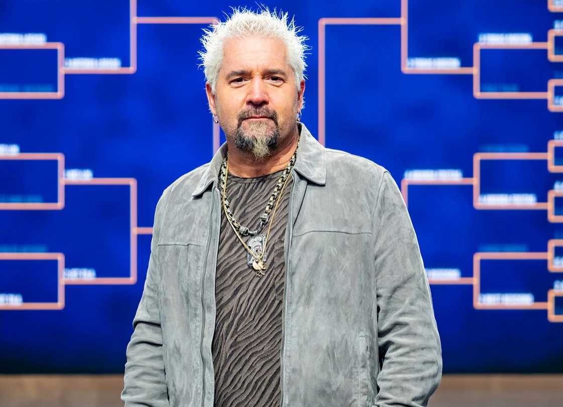 Guy Fieri poses while hosting a culinary competition Guy Fieri poses while hosting a culinary competition