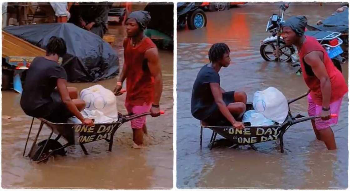 Man pushes a woman in a wheelbarrow.