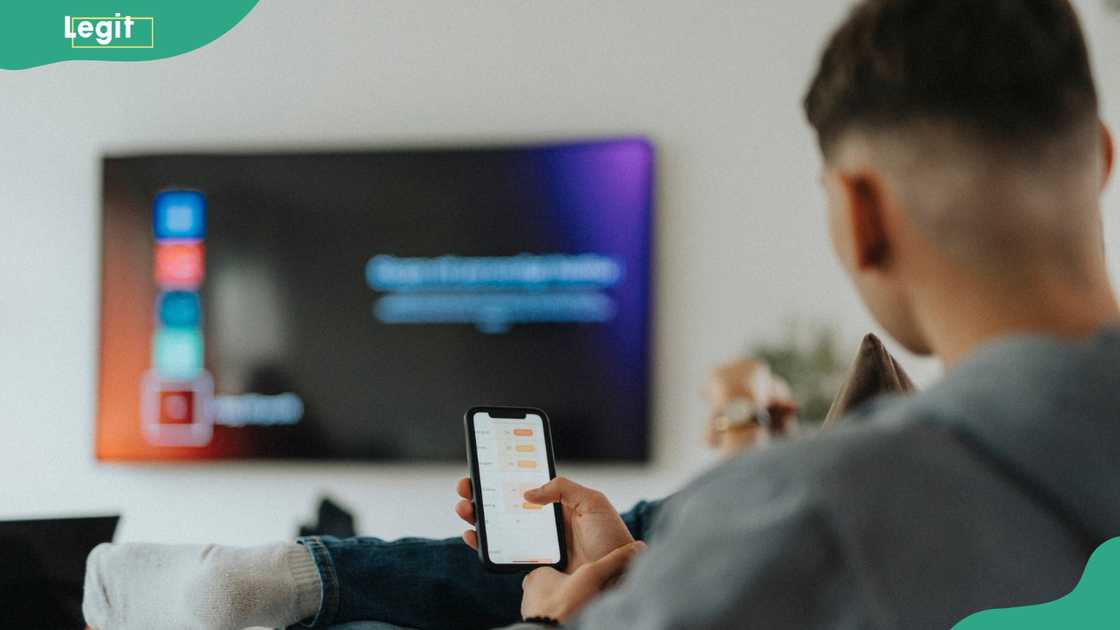 A person connecting their phone to a smart TV