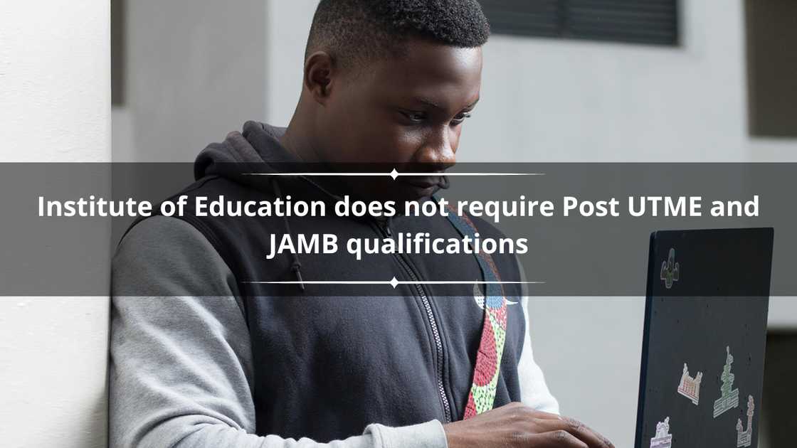 A young man using his laptop while standing A young man using his laptop while standing