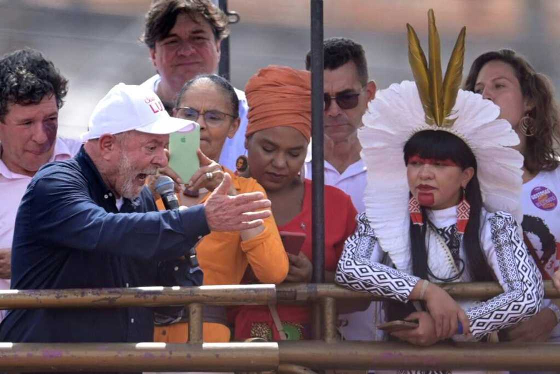 Celia Xakriaba, right, listens to leftist former President Luiz Inacio Lula da Silva at a rally in Brazil's Minas Gerais state on October 22, 2022