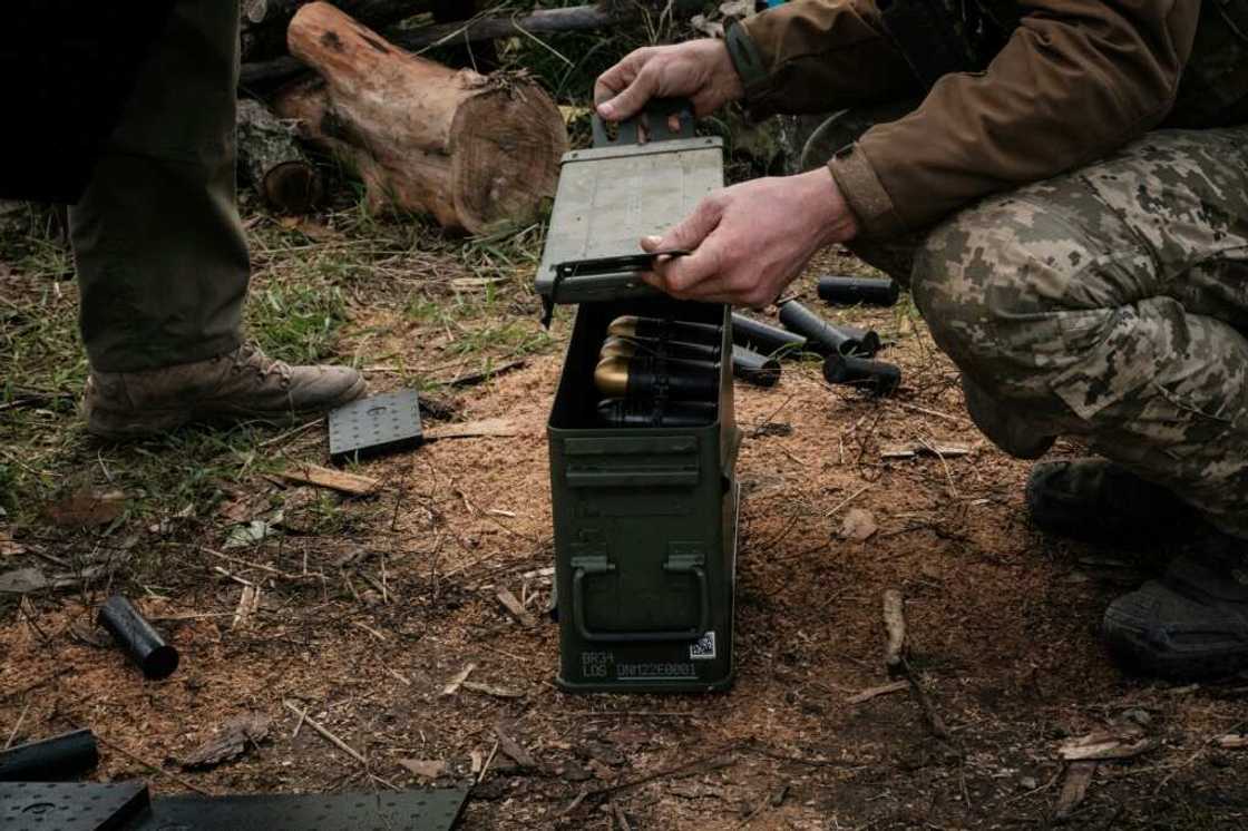 Soldiers of Ukraine's 5th Regiment of Assault Infantry put ammunition into a crate before setting a US-made MK-19 automatic grenade launcher towards Russian positions in less than 800 metres away at a front line near Toretsk in the Donetsk region