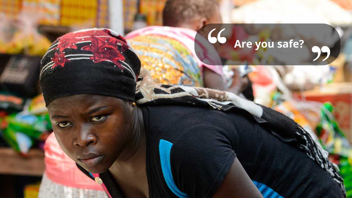 A saleswoman bending at the market while talking A saleswoman bending at the market while talking