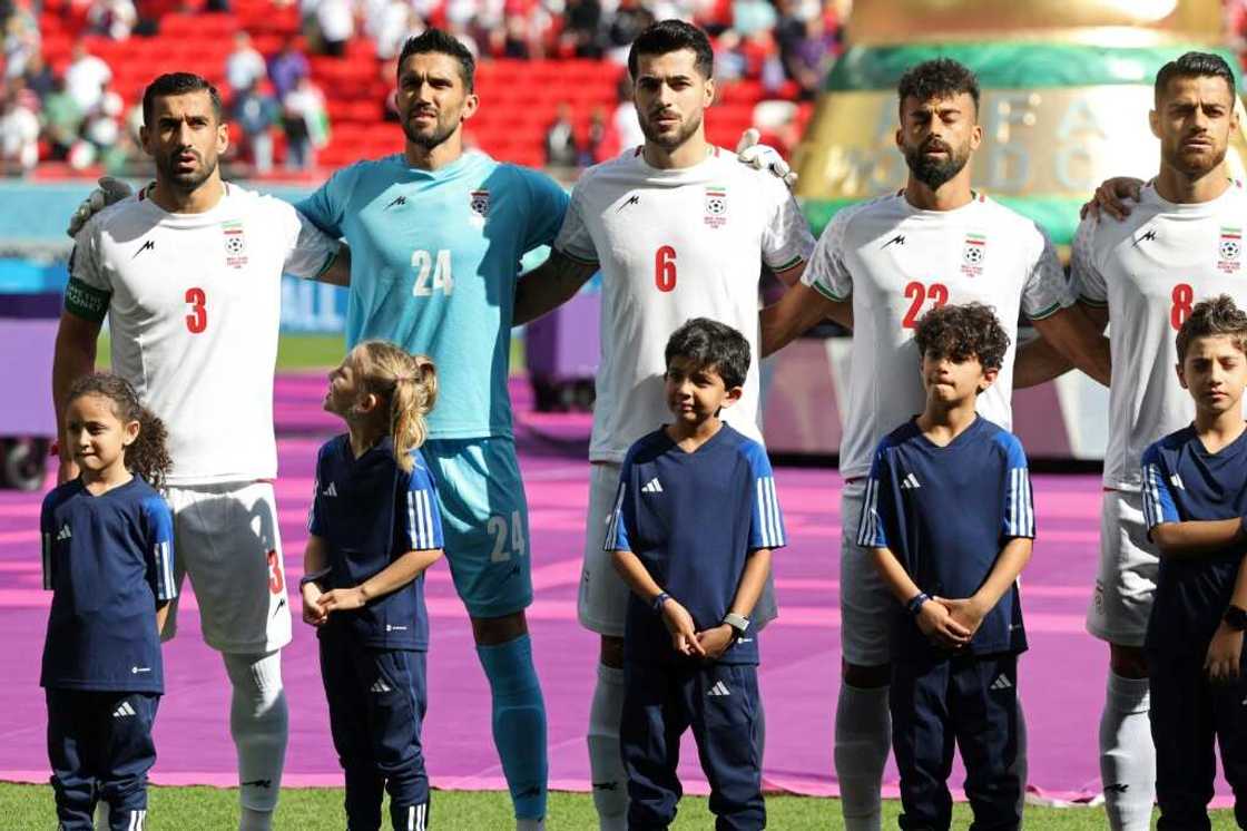 Iran's players sing their national anthem prior to the game against Wales Iran's players sing their national anthem prior to the game against Wales