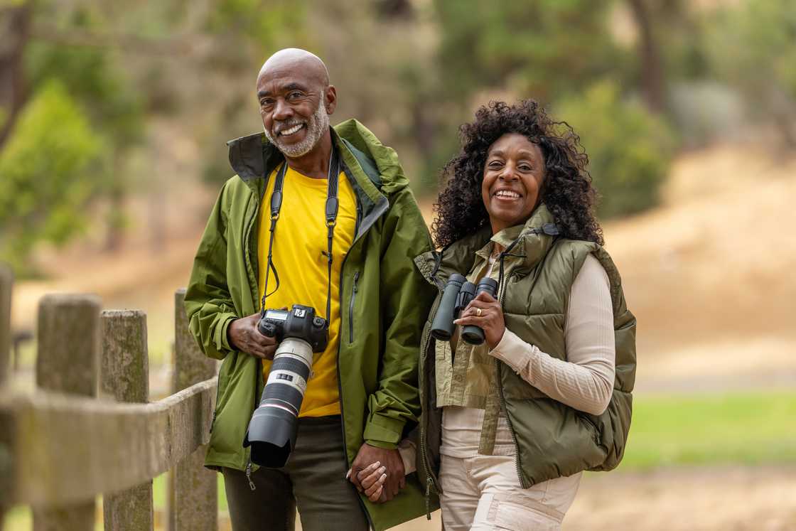 A couple on a outdoor walk and hike enjoying bird watching and photography