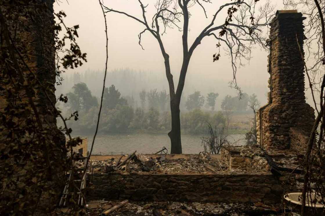 A chimney is all that remains of a river-front home in Klamath River northwest of Yreka, California A chimney is all that remains of a river-front home in Klamath River northwest of Yreka, California
