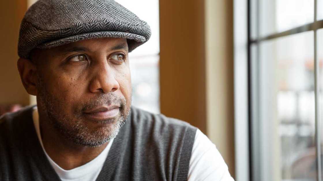 A mature man looking through the window. A mature man looking through the window.