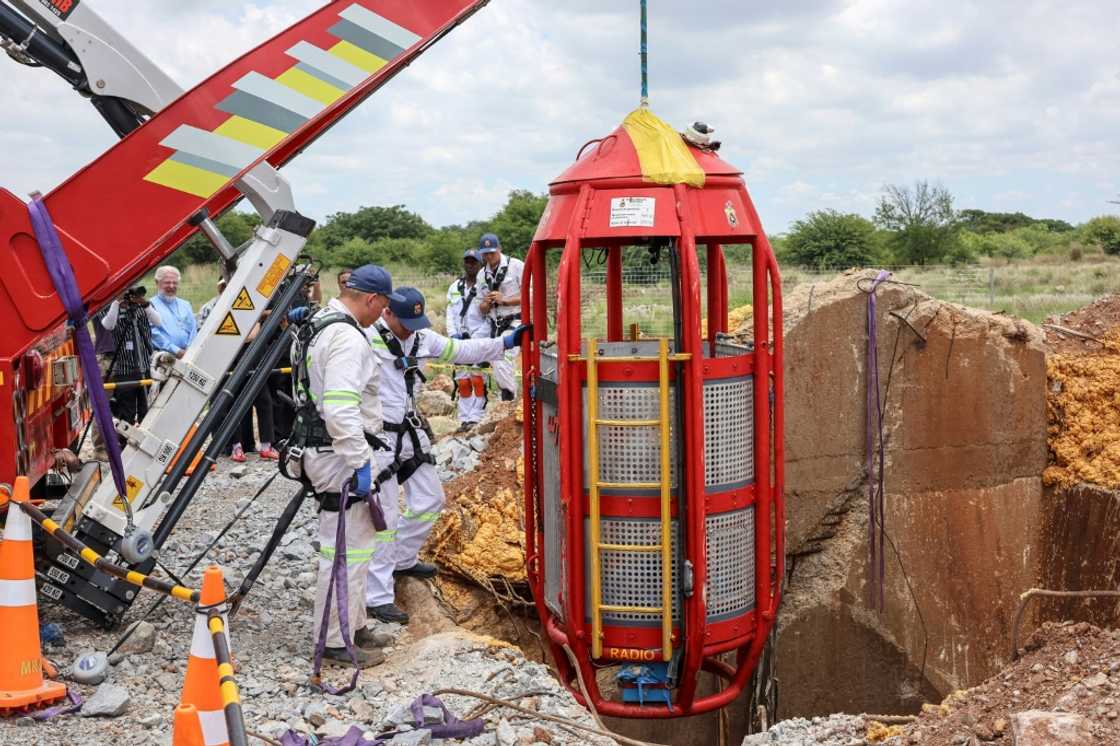 Rescuers sent down a specialised machine with a cage to lift the miners out Rescuers sent down a specialised machine with a cage to lift the miners out