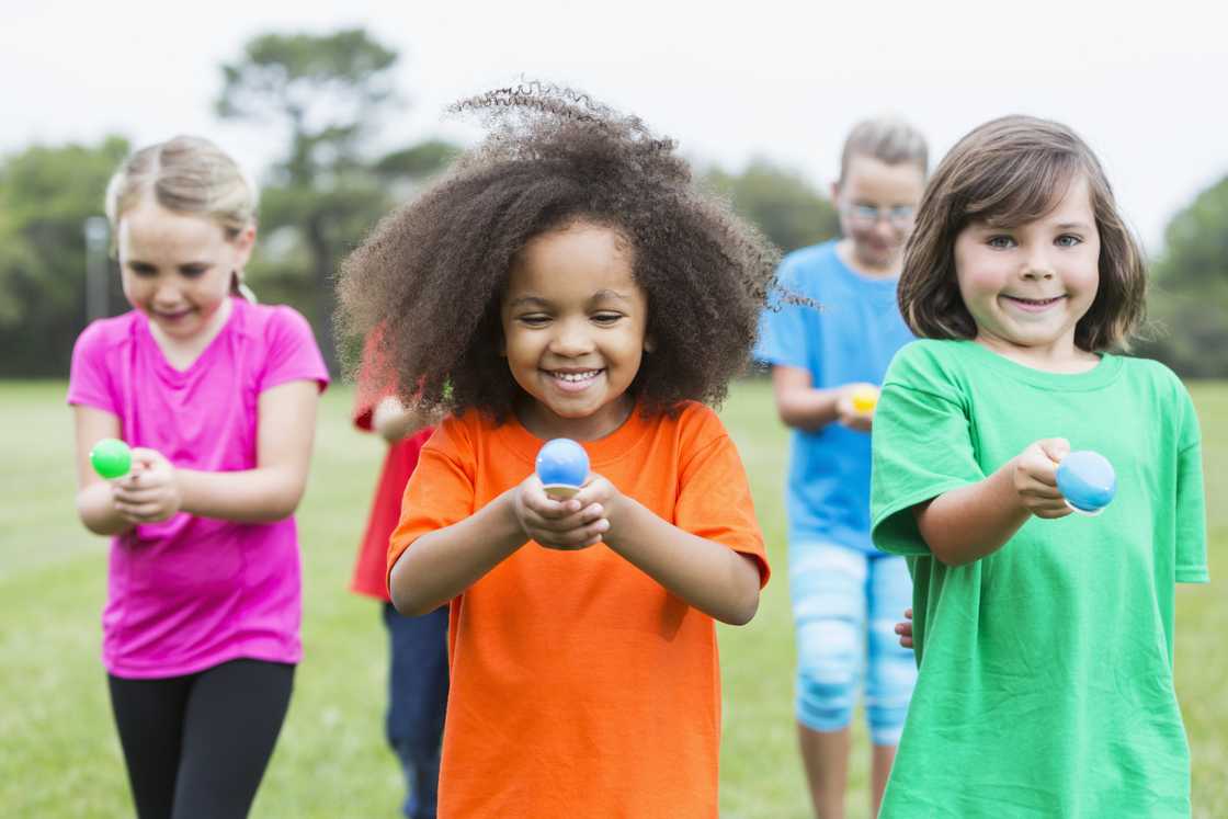 Elementary kids playing the Egg and Spoon Race