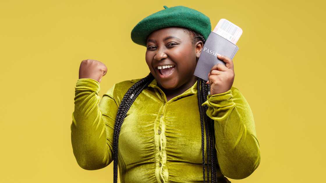A woman holding a passport. A woman holding a passport.