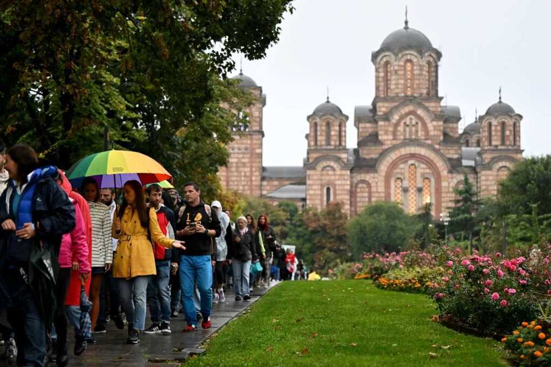 The Pride marchers walk past an Orthodox church in Belgrade The Pride marchers walk past an Orthodox church in Belgrade