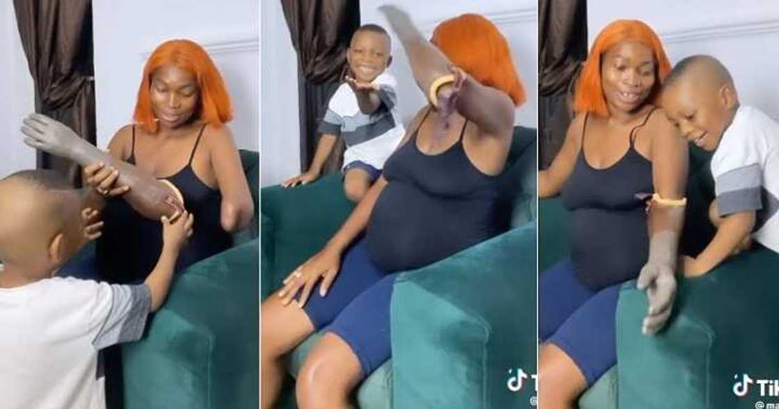 Little boy laughs at mum wearing artificial hand Little boy laughs at mum wearing artificial hand