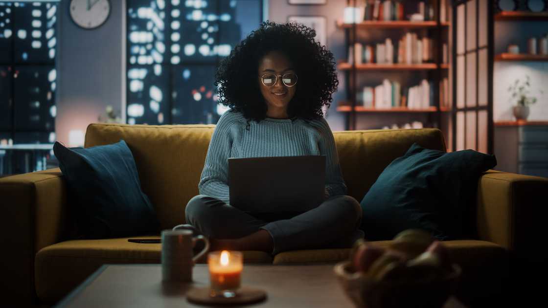 A lady at home with a burning candle