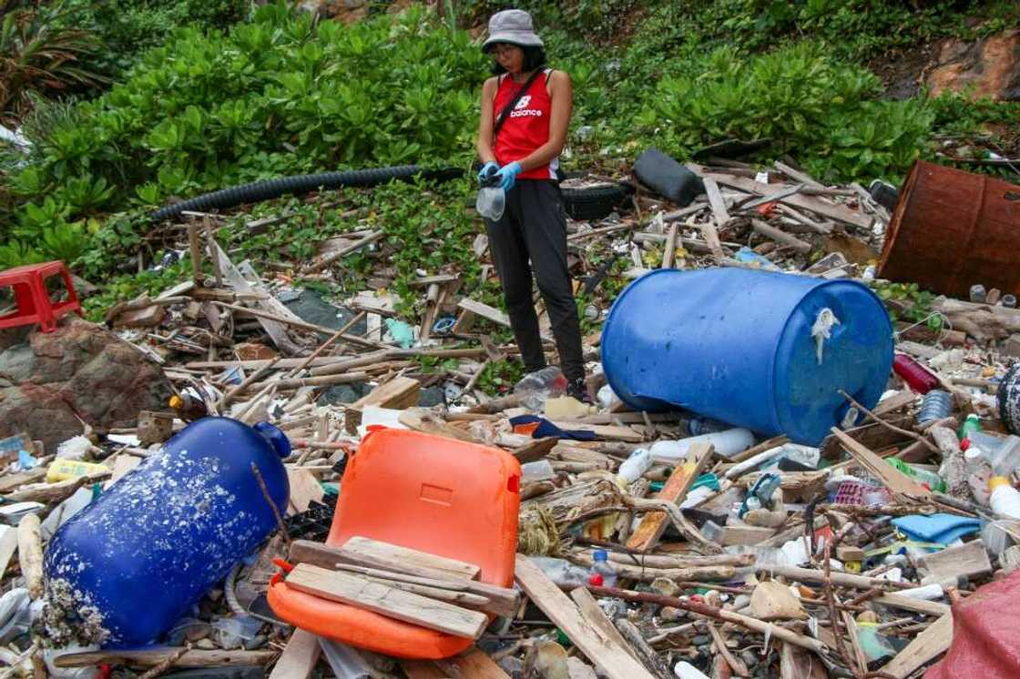 Environmental educator Yeungs Ting collects plastic waste at a beach cleaning in Hong Kong Environmental educator Yeungs Ting collects plastic waste at a beach cleaning in Hong Kong