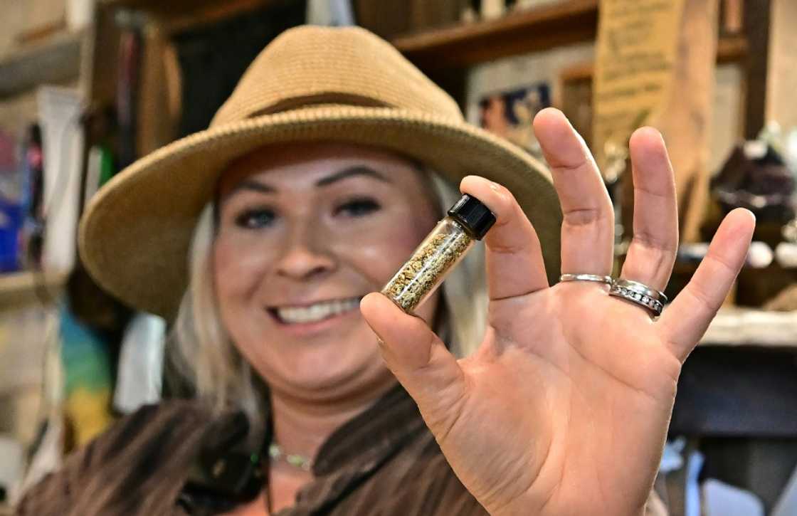 Nikaila Delorenzi, whose family runs Matelot Gulch Mining Company in California's Columbia State Historic Park, holds a vial containing $4,000 worth of gold