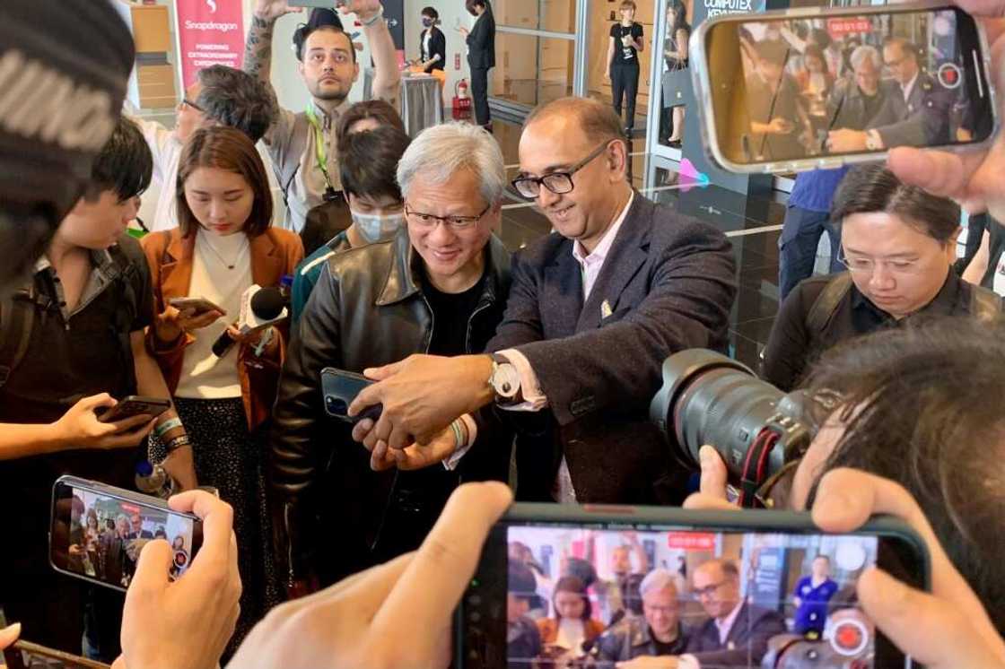 Nvidia chief Jensen Huang (centre L) poses for photographs before attending a press conference at Computex 2023 in Taipei on May 30, 2023. Nvidia chief Jensen Huang (centre L) poses for photographs before attending a press conference at Computex 2023 in Taipei on May 30, 2023.