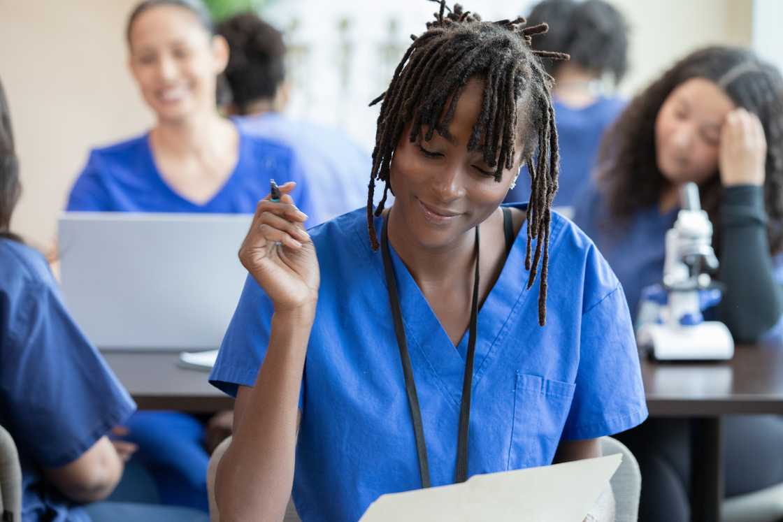 A nursing student takes notes during a healthcare conference