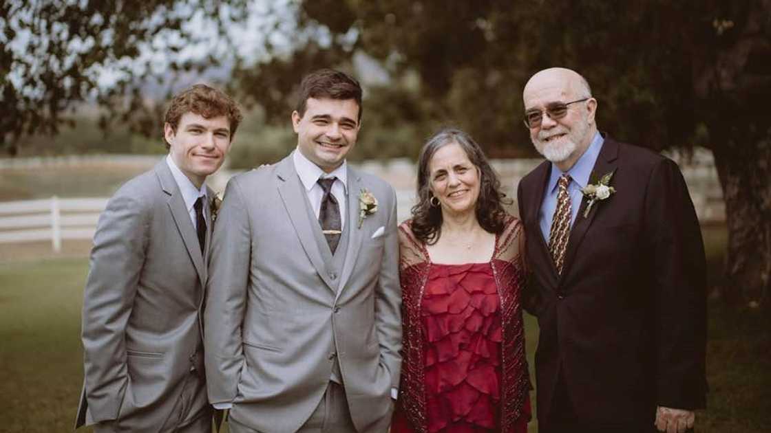 Eve Alda Coffey (C) poses outdoors with her husband and sons. Eve Alda Coffey (C) poses outdoors with her husband and sons.
