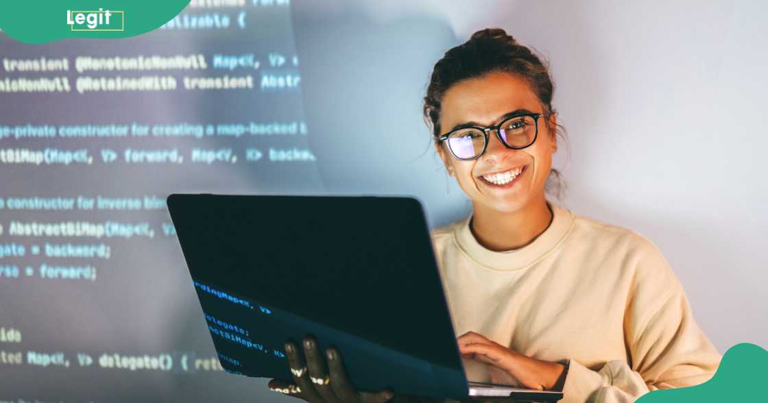 A programmer working on a laptop