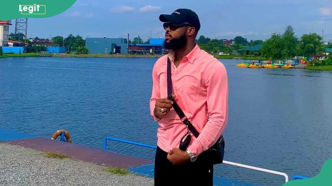 Denari from BBNaija takes a photo by the water park.