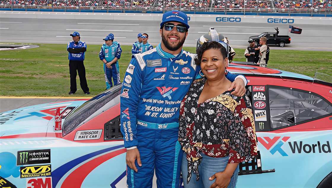 Bubba Wallace posing with his mother, Desiree Wallace, at a race event. Bubba Wallace posing with his mother, Desiree Wallace, at a race event.