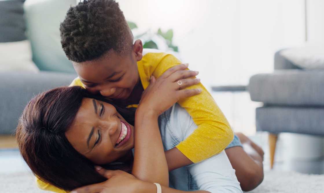 A woman spending time with a little boy at home