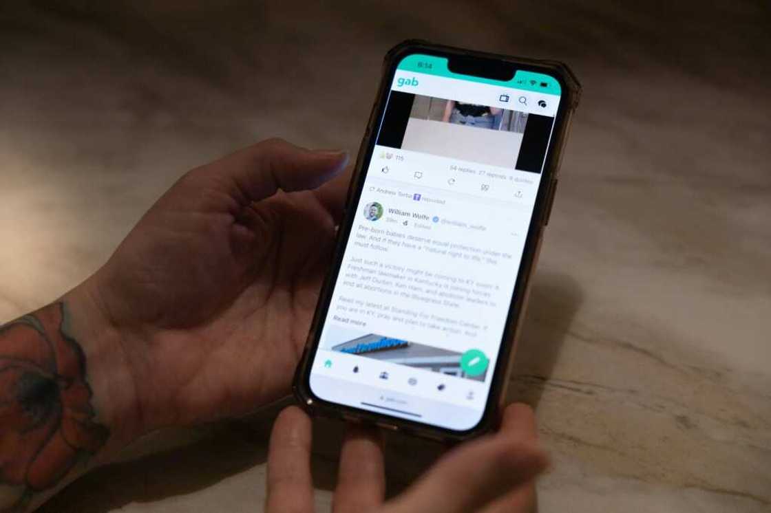 Jessica Watt looks at Gab on her phone, an app that her father, Randy Watt, turned to regularly Jessica Watt looks at Gab on her phone, an app that her father, Randy Watt, turned to regularly