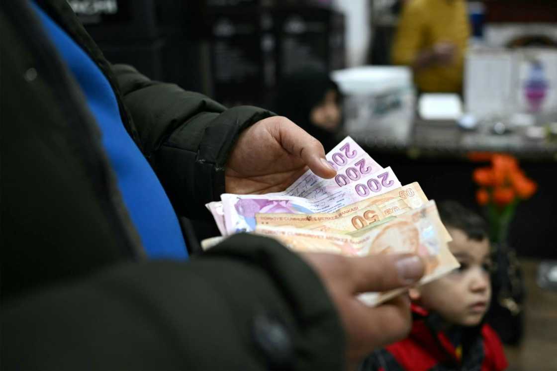 A man counts Turkish lira at a shop in Dana, which has become a retail hotspot since Assad's fall A man counts Turkish lira at a shop in Dana, which has become a retail hotspot since Assad's fall