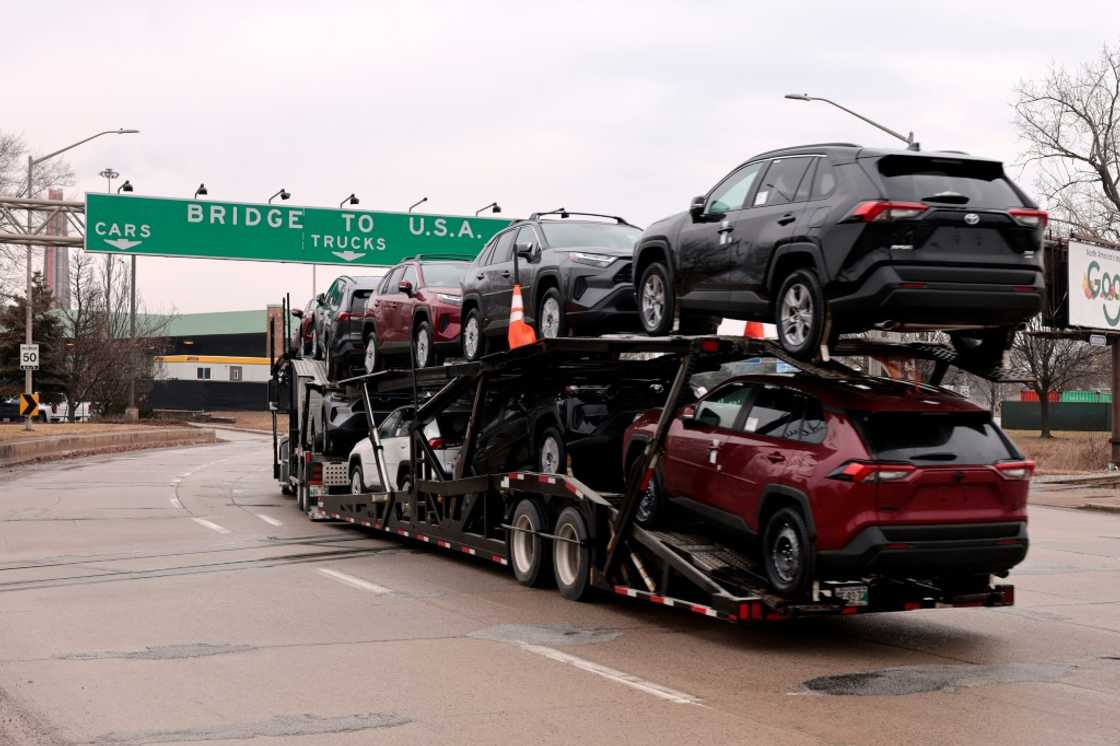 A car hauler carries Toyota RAV4 vehicles as it enters to cross the Ambassador Bridge in Windsor, Ontario to go to Detroit, Michigan on February 3, 2025