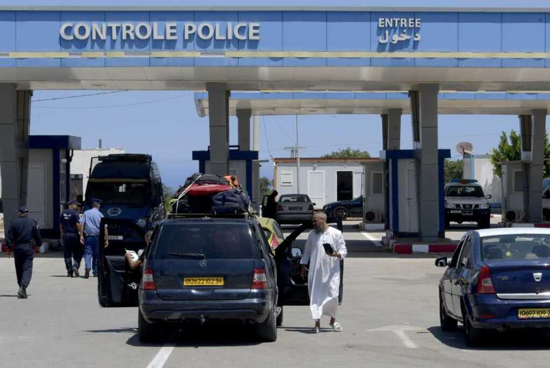 Travellers gather at Tunisia's Tabarka border post with Algeria after it reopened on July 15, two years on from its closure due to the Covid-19 pandemic Travellers gather at Tunisia's Tabarka border post with Algeria after it reopened on July 15, two years on from its closure due to the Covid-19 pandemic