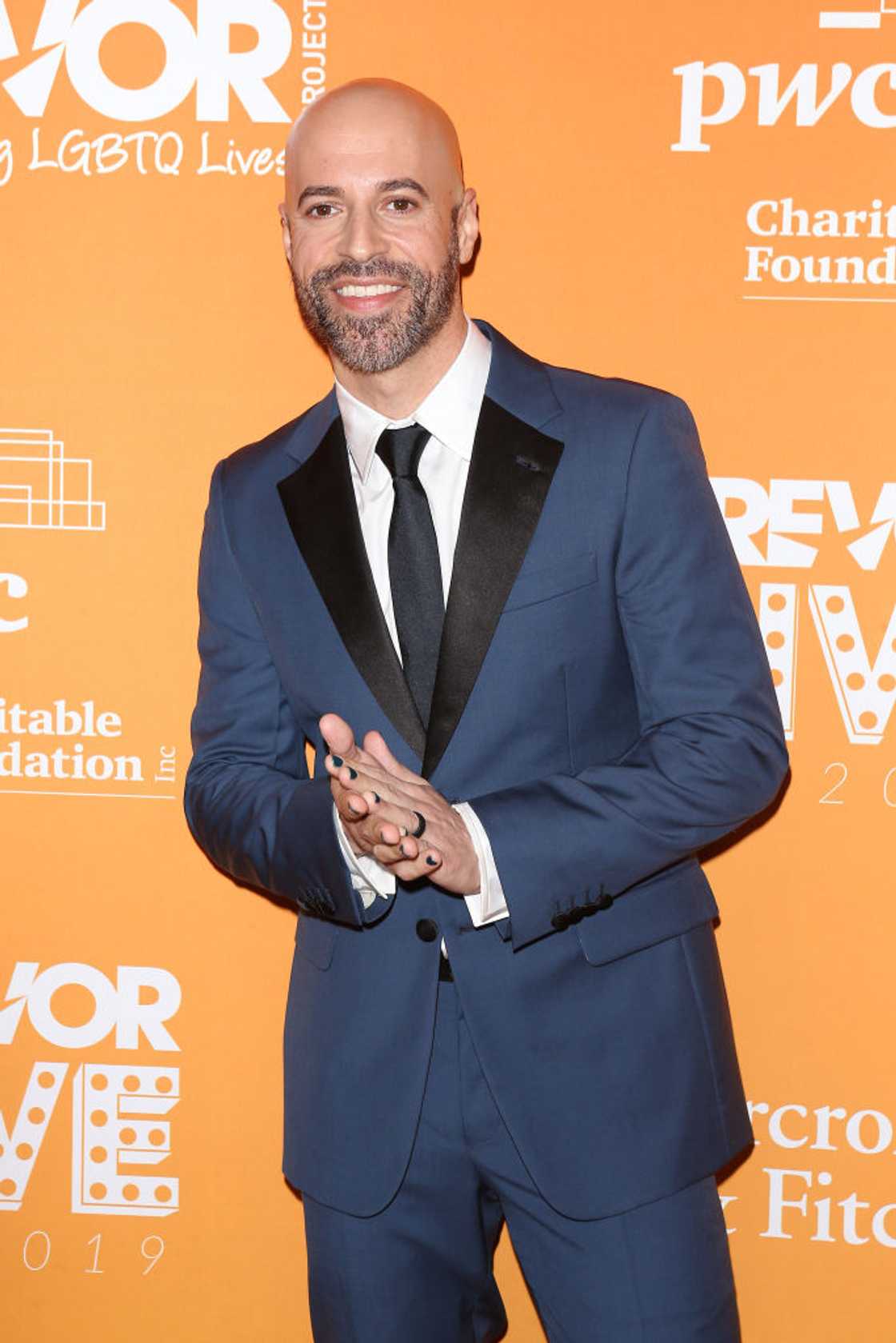 Chris Daughtry in a blue suit, white shirt and black tie, smiling at the camera at the TrevorLive Los Angeles Gala at The Beverly Hilton, 2019