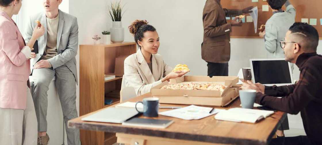 People having pizza at the office