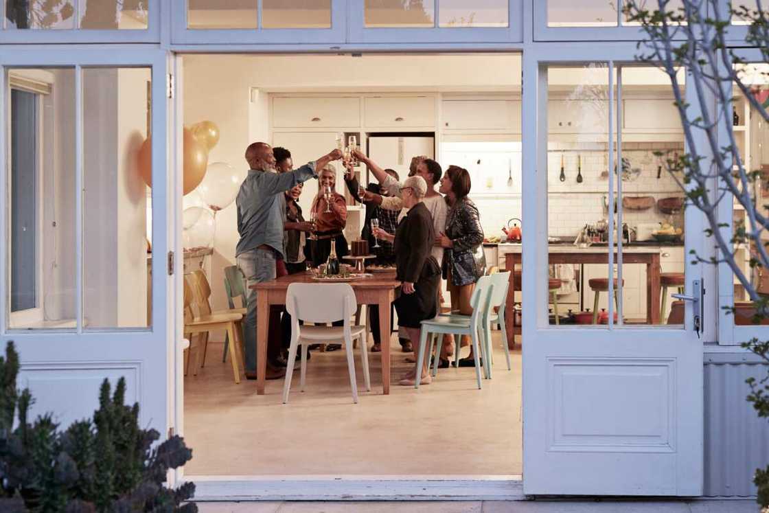 Cheerful people toasting drinks during a party