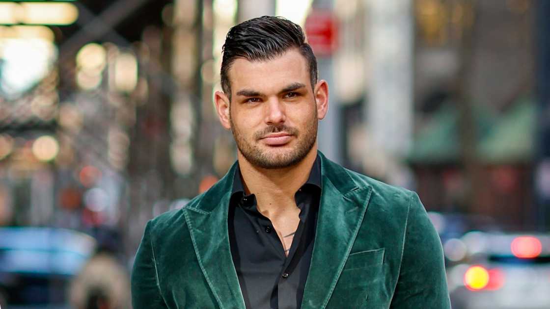 Romain Bonnet pictured in a green suit while walking in New York City.