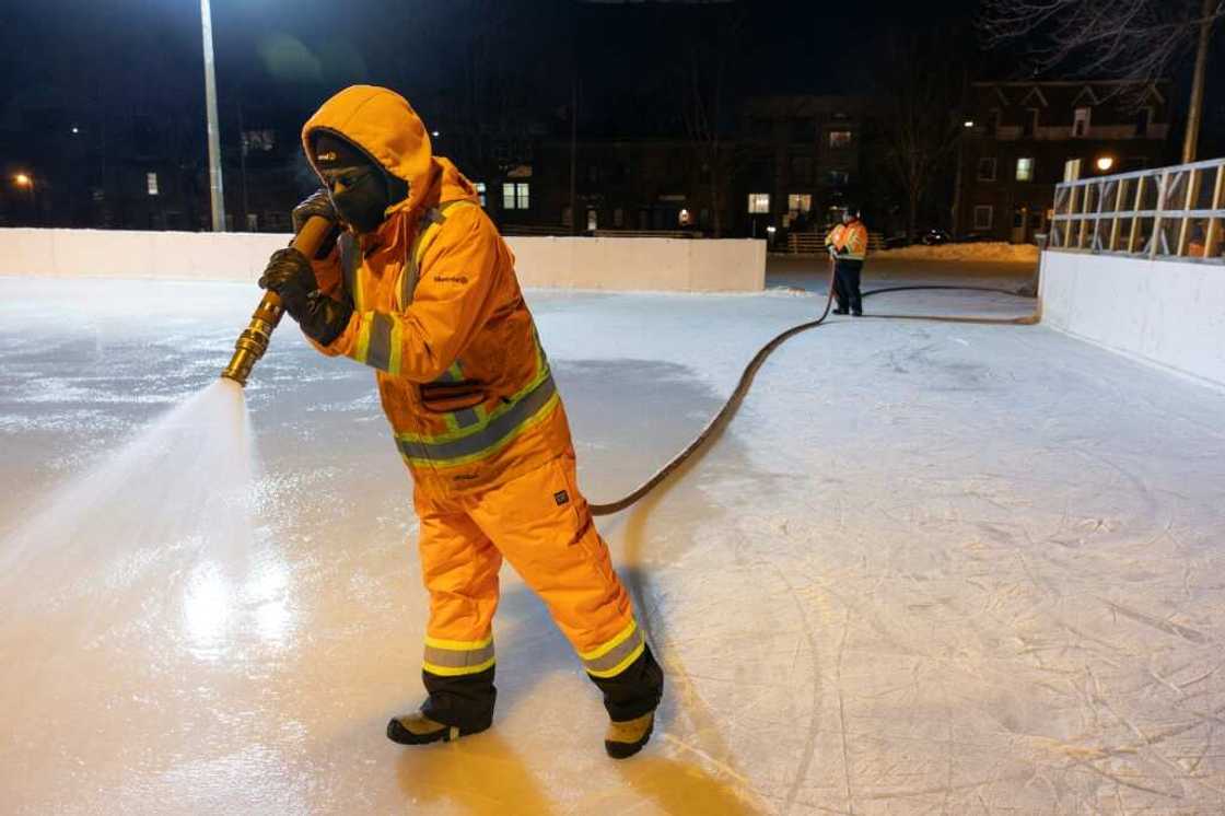 A worker sprays water at the Hibernia Square ice rink in Montreal to thicken fresh ice A worker sprays water at the Hibernia Square ice rink in Montreal to thicken fresh ice