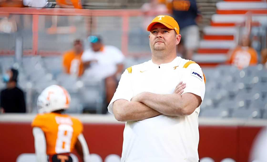 Josh Heupel poses on a football field