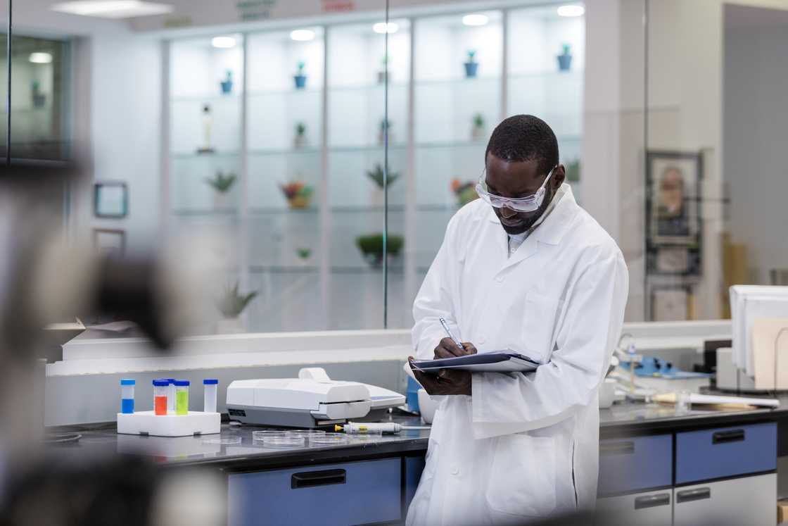 A male scientist documents results of experiments on nutritional supplements. A male scientist documents results of experiments on nutritional supplements.