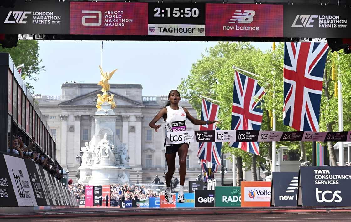 Ethiopia's Tigst Assefa reacts as she crosses the line to win the women's race at the 2025 London Marathon