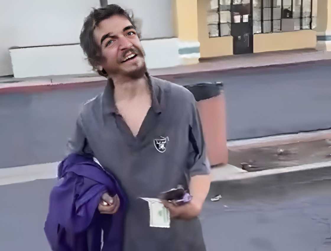 Tylor Chase holds a phone and other items