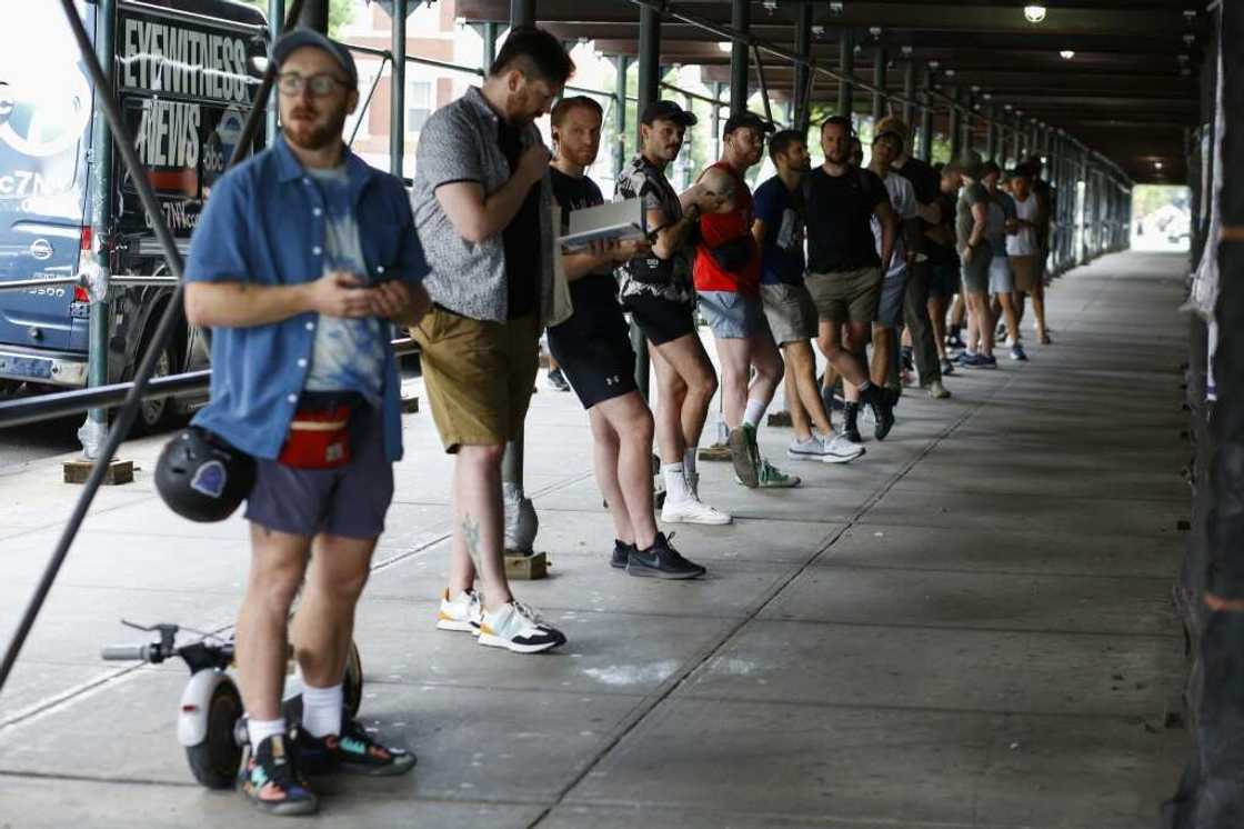 People wait in line to receive the monkeypox vaccine outside a vaccination center in Brooklyn, New York